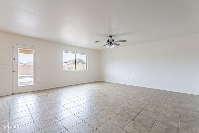 unfurnished room with ceiling fan and light tile patterned floors