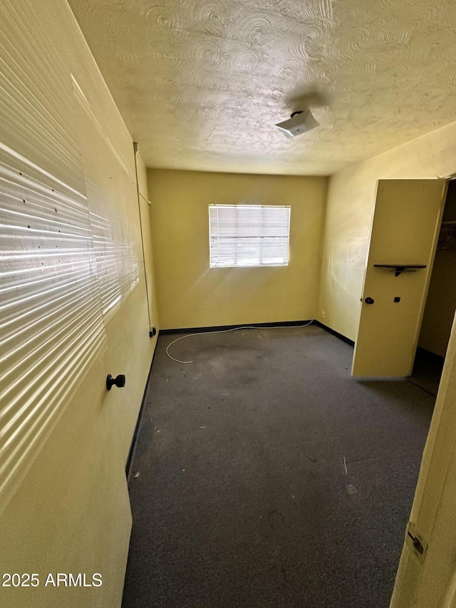 spare room with a textured ceiling