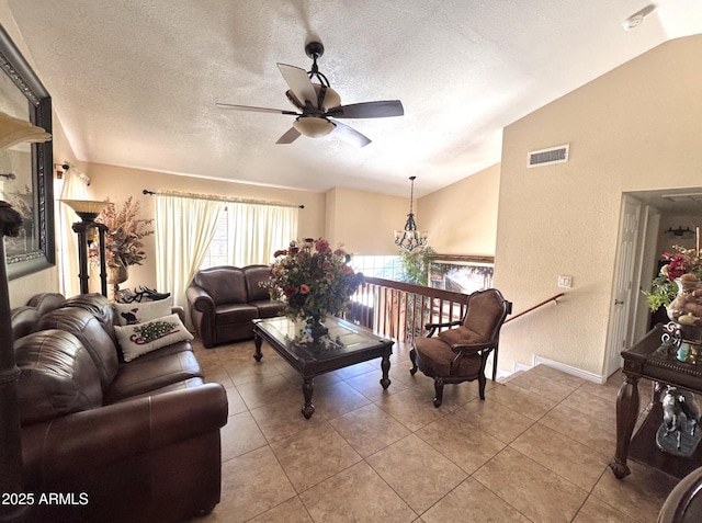 8908 W Sheridan St, Phoenix, AZ 85037 - living area featuring lofted ceiling, ceiling fan, tile patterned floors, a textured ceiling, and a chandelier