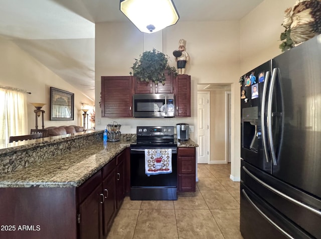8908 W Sheridan St, Phoenix, AZ 85037 - kitchen featuring refrigerator with ice dispenser, stainless steel microwave, black range with electric cooktop, a peninsula, and light tile patterned floors
