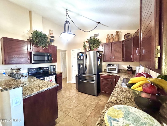 8908 W Sheridan St, Phoenix, AZ 85037 - kitchen featuring stainless steel appliances, light tile patterned floors, reddish brown cabinets, lofted ceiling, and a peninsula
