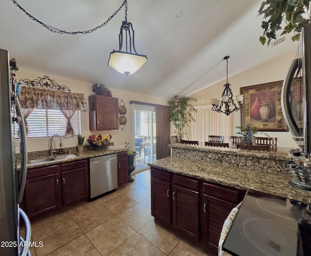 8908 W Sheridan St, Phoenix, AZ 85037 - kitchen featuring appliances with stainless steel finishes, lofted ceiling, plenty of natural light, light tile patterned floors, and hanging light fixtures