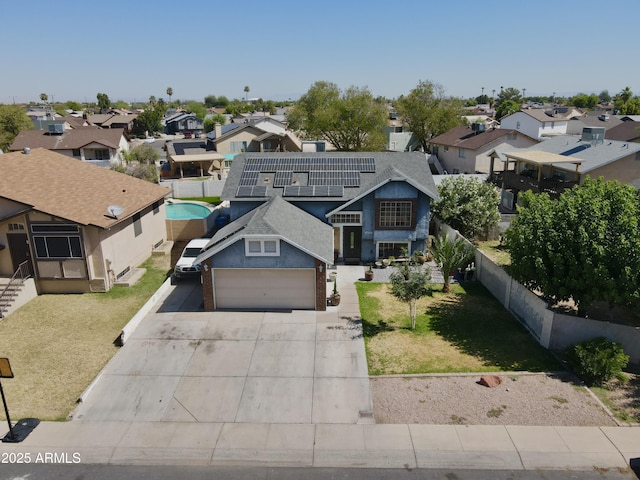 8908 W Sheridan St, Phoenix, AZ 85037 - view of front of home featuring a residential view, concrete driveway, solar panels, and a garage
