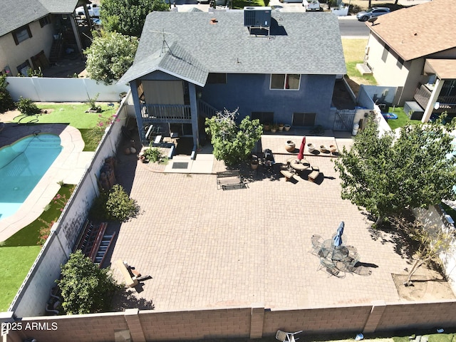 8908 W Sheridan St, Phoenix, AZ 85037 - rear view of house with roof with shingles, a fenced backyard, stucco siding, and a patio area