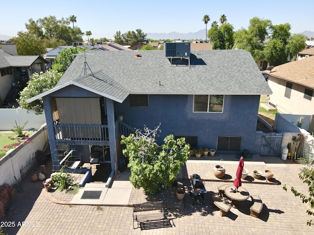 8908 W Sheridan St, Phoenix, AZ 85037 - view of front of home with roof with shingles, a patio area, a gate, stucco siding, and a mountain view