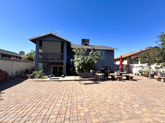 8908 W Sheridan St, Phoenix, AZ 85037 - rear view of house with a patio and stucco siding