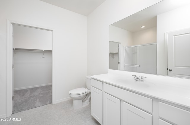 bathroom with vanity, tile patterned flooring, a shower with door, and toilet