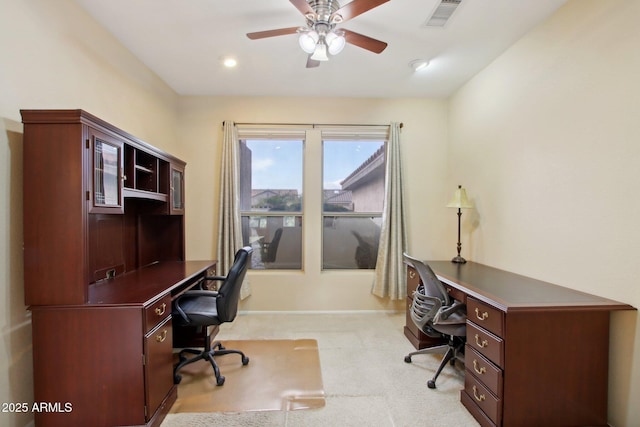 carpeted office space with ceiling fan