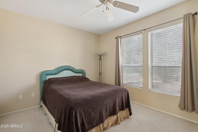 bedroom with ceiling fan and light colored carpet