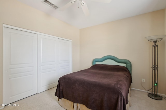 bedroom with light carpet, a closet, and ceiling fan