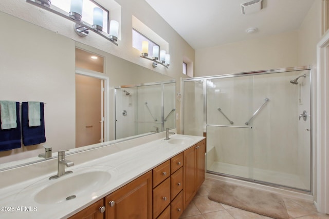 bathroom with vanity, a shower with door, and tile patterned floors