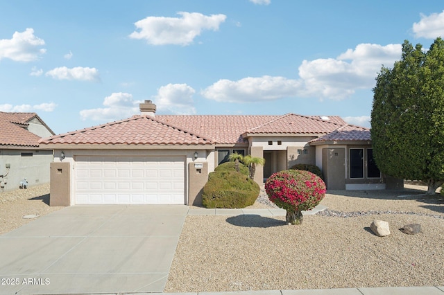 mediterranean / spanish-style home with a garage