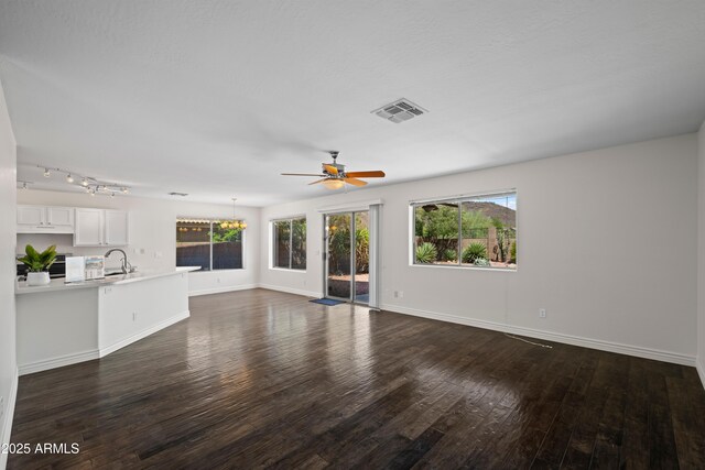 2168 E Vista Bonita Dr, Phoenix, AZ 85024 - unfurnished living room with a ceiling fan, dark wood-style flooring, a sink, and baseboards