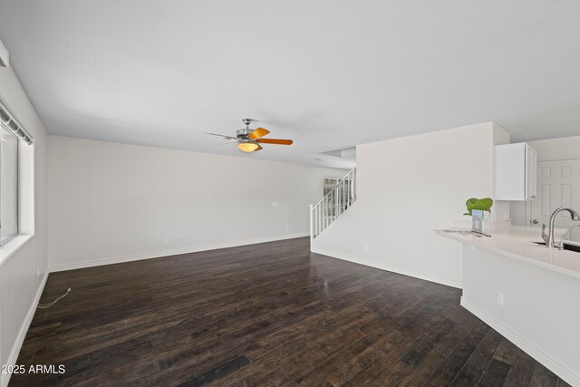 2168 E Vista Bonita Dr, Phoenix, AZ 85024 - unfurnished living room featuring ceiling fan, dark wood finished floors, stairs, and baseboards