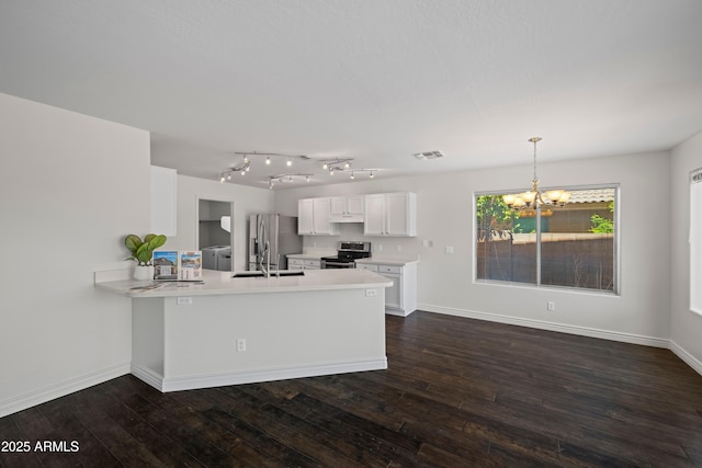 2168 E Vista Bonita Dr, Phoenix, AZ 85024 - kitchen with appliances with stainless steel finishes, a chandelier, a peninsula, dark wood-type flooring, and light countertops