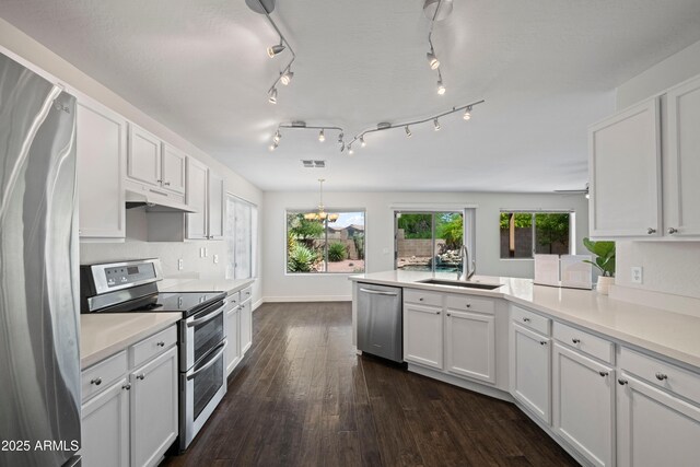 2168 E Vista Bonita Dr, Phoenix, AZ 85024 - kitchen featuring stainless steel appliances, a sink, a peninsula, white cabinetry, and dark wood-style flooring