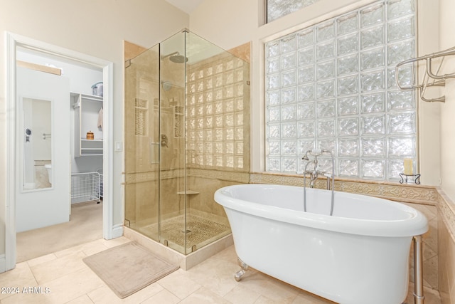 bathroom featuring shower with separate bathtub and tile patterned floors