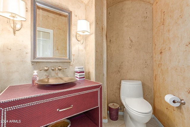 bathroom with tile patterned flooring, vanity, and toilet