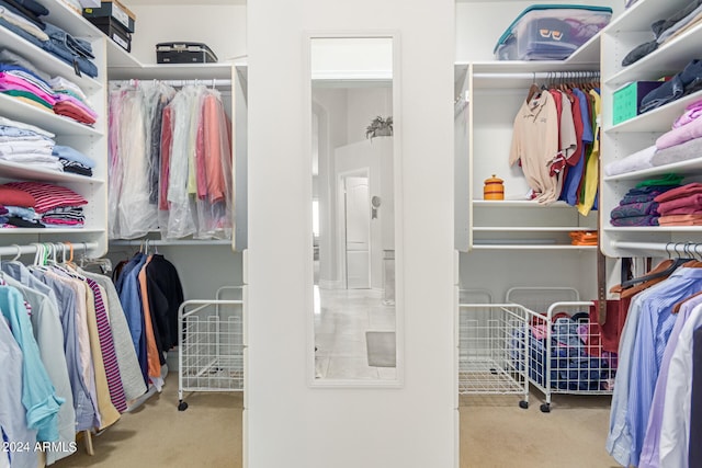 spacious closet featuring light carpet