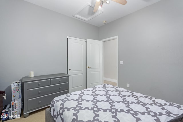 carpeted bedroom with a closet and ceiling fan