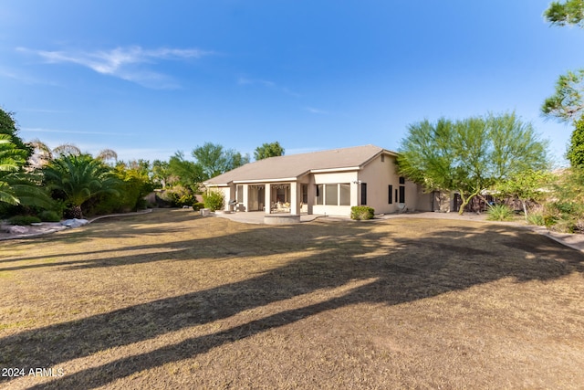 view of front facade featuring a front lawn and a sunroom