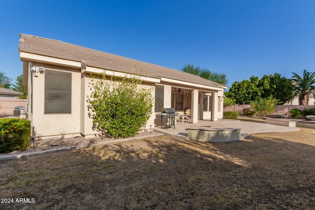 rear view of property featuring a patio area