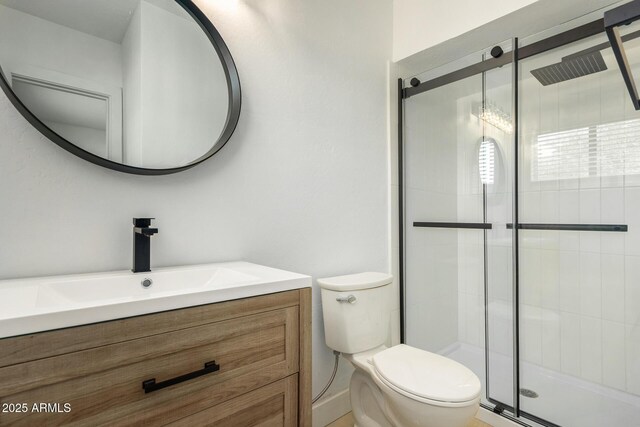 bathroom featuring walk in shower, vanity, and toilet