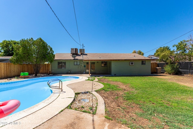 view of swimming pool featuring a patio, central AC, and a lawn