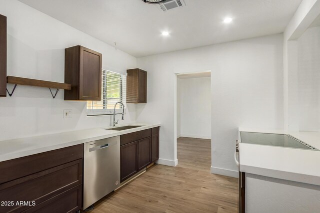 kitchen featuring dishwasher, dark brown cabinetry, light hardwood / wood-style flooring, and sink