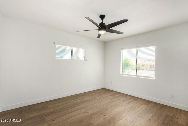 unfurnished room featuring ceiling fan, a healthy amount of sunlight, and light wood-type flooring