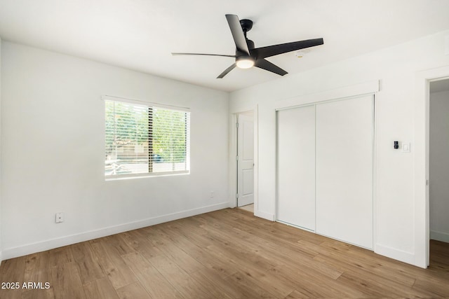 unfurnished bedroom with ceiling fan, light hardwood / wood-style floors, and a closet