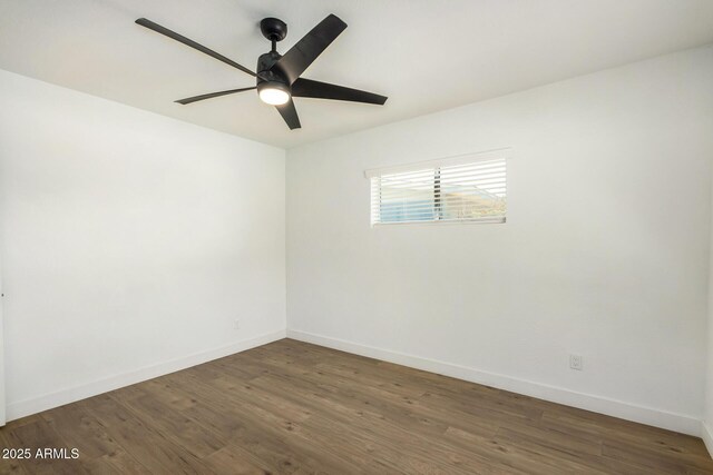 empty room featuring ceiling fan and dark wood-type flooring