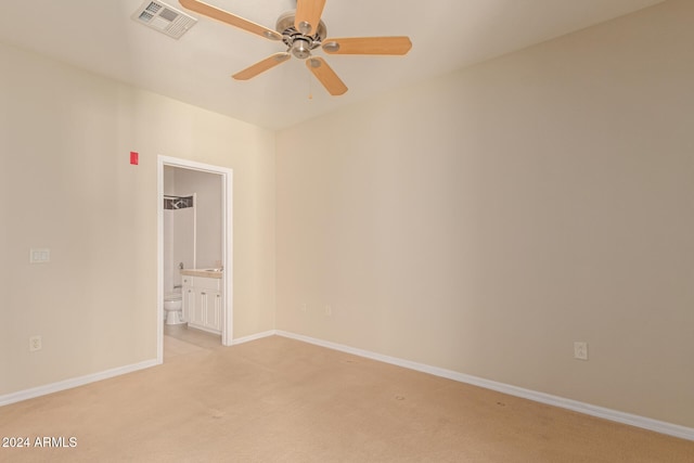 unfurnished room featuring baseboards, ceiling fan, visible vents, and light colored carpet