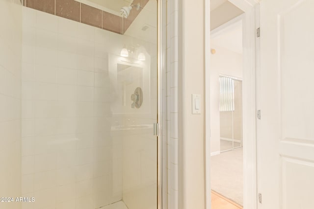 bathroom featuring a shower with shower door