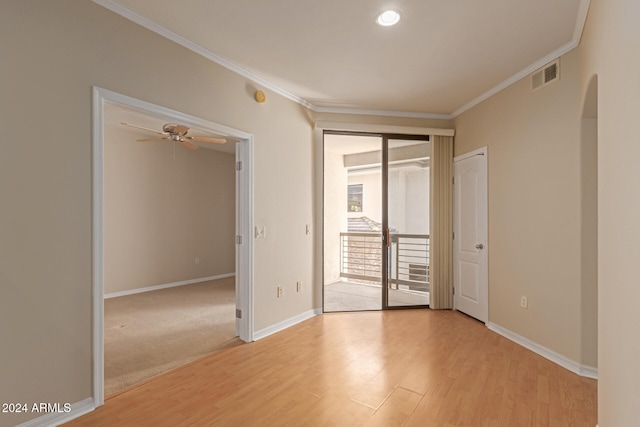 empty room featuring light hardwood / wood-style floors, ceiling fan, and ornamental molding