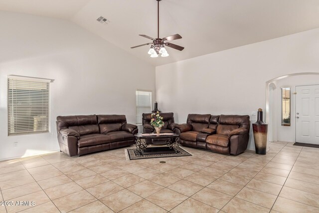 136 N 236th Ave, Buckeye, AZ 85396 - living area featuring high vaulted ceiling, a ceiling fan, light tile patterned floors, visible vents, and arched walkways