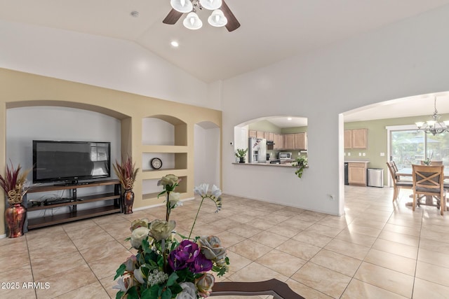136 N 236th Ave, Buckeye, AZ 85396 - living room featuring ceiling fan with notable chandelier, lofted ceiling, built in features, and light tile patterned floors