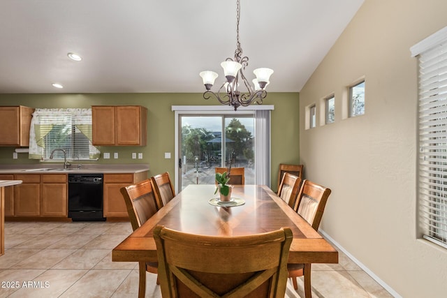 136 N 236th Ave, Buckeye, AZ 85396 - dining space with baseboards, a notable chandelier, vaulted ceiling, and light tile patterned floors