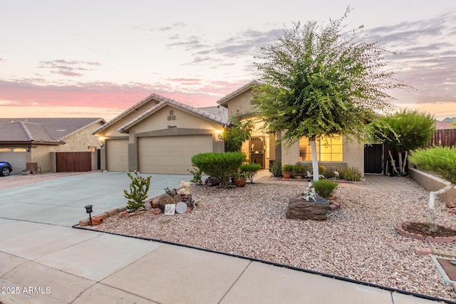 136 N 236th Ave, Buckeye, AZ 85396 - view of front facade featuring fence, a garage, concrete driveway, a tile roof, and stucco siding