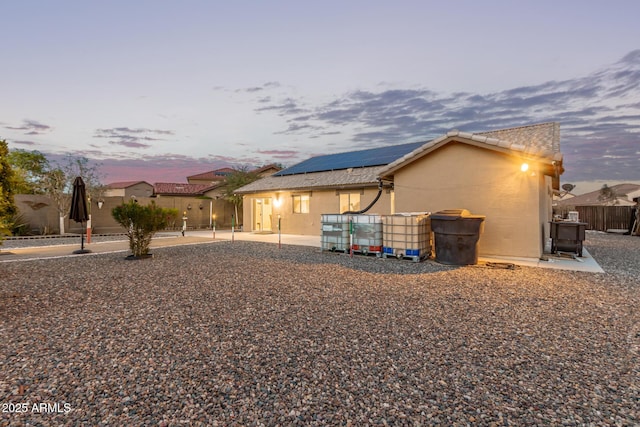 136 N 236th Ave, Buckeye, AZ 85396 - rear view of property with stucco siding, solar panels, fence, and a patio area