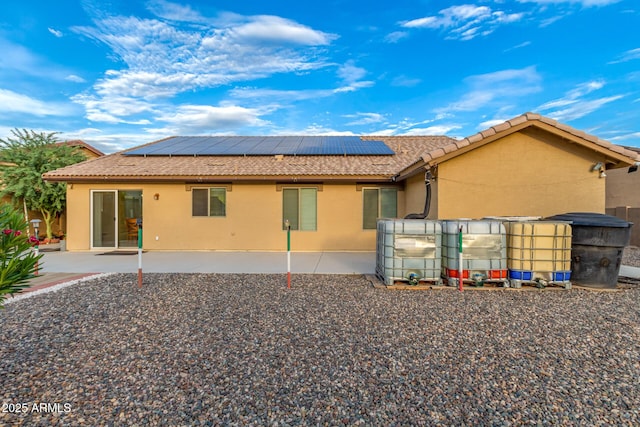 136 N 236th Ave, Buckeye, AZ 85396 - back of house with a tile roof, stucco siding, a patio area, and solar panels