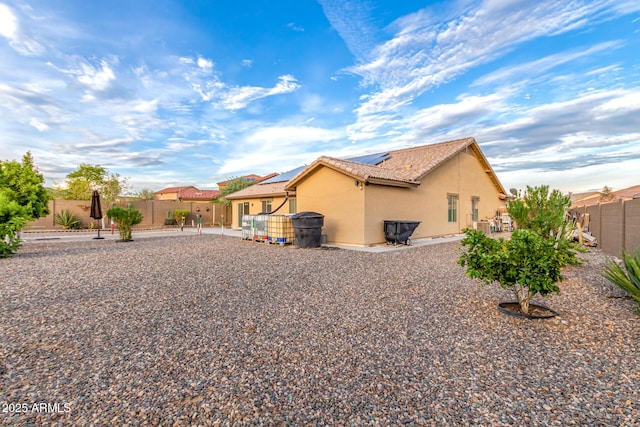 136 N 236th Ave, Buckeye, AZ 85396 - rear view of property featuring stucco siding, a patio, a fenced backyard, a tiled roof, and solar panels