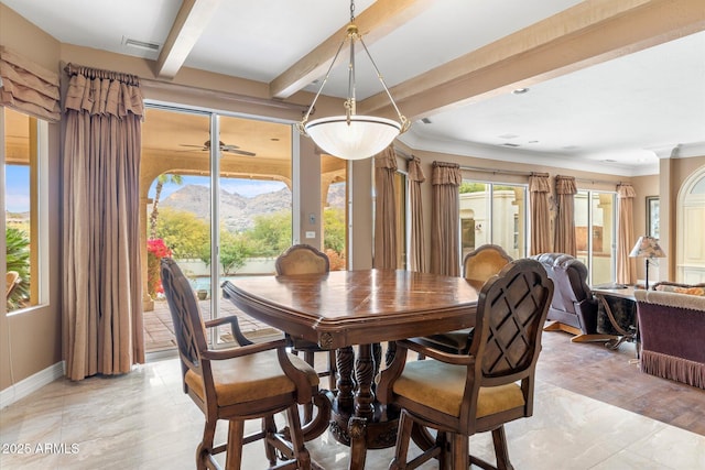 dining room featuring a mountain view, ornamental molding, and beamed ceiling