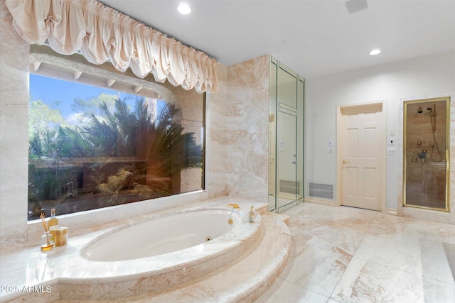 bathroom featuring separate shower and tub