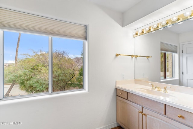 bathroom featuring a healthy amount of sunlight and vanity