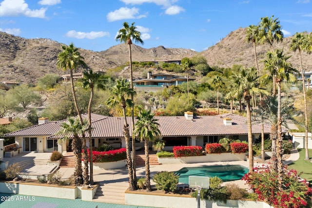 view of swimming pool featuring a mountain view and a patio