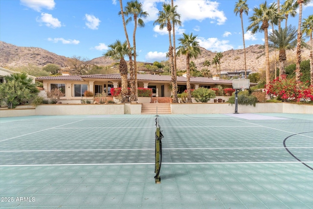 view of sport court featuring a mountain view and basketball court