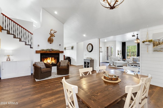 dining room featuring wooden walls, dark hardwood / wood-style floors, and lofted ceiling