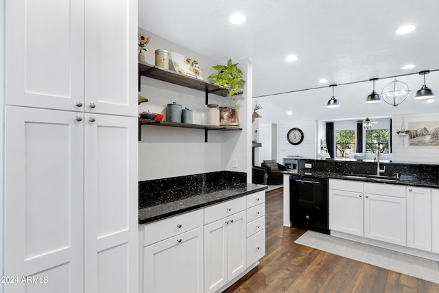 kitchen featuring black dishwasher, white cabinetry, sink, dark stone countertops, and dark wood-type flooring