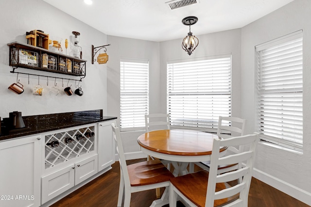 dining room featuring dark wood-type flooring and a notable chandelier